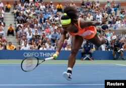 Serena Williams of the US is unable to reach a return by Roberta Vinci of Italy in the third set during their women's singles semi-final match at the US Open Championships tennis tournament in New York, Sept. 11, 2015.