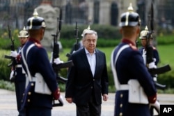 U.N. Secretary-General Antonio Guterres walks past an honor guard during a welcoming ceremony at the presidential palace in Bogota, Colombia, Saturday, Jan. 13, 2018.