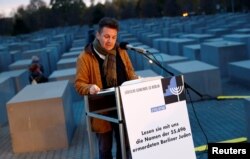 A volunteer of Berlin's Jewish community reads out all names of Jews killed in the city during the Holocaust at the Holocaust Memorial on the eve of the 80th anniversary of Kristallnacht, also known as Night of Broken Glass, a state-sponsored spree of looting and destruction of Jewish property across Germany and Austria in Berlin, Nov. 8, 2018.