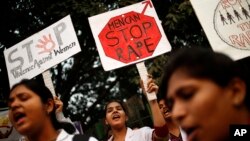 FILE - Indian physiotherapy students hold placards at a rally rape in India.