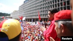 Venezuela's President Nicolas Maduro, right, attends a pro-government gathering in Caracas, Venezuela, Aug. 30, 2016.