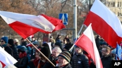 FILE - Supporters of the Committee for the Defense of Democracy movement stage a protest against the government in Warsaw, Jan. 23, 2016. 