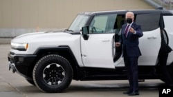 President Joe Biden gets into a Hummer for a test drive at the General Motors Factory ZERO electric vehicle assembly plant during a tour of the plant, in Detroit, Michigan, Nov. 17, 2021. 