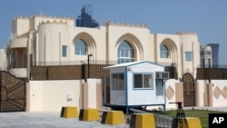 FILE - The new office of the Afghan Taliban in Doha, Qatar is seen after the opening of the office, June 20, 2013 . 