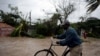 A man pushes a bicycle in a flood zone after Hurricane Matthew passed through Les Cayes, Haiti, Oct. 4, 2016. 