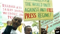 FILE - Ethiopian journalists hold placards as they shout slogans during a demonstration at the Ethiopian Embassy in Nairobi, May 2, 2006.