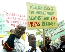 FILE - Ethiopian journalists hold placards as they shout slogans during a demonstration at the Ethiopian Embassy in Nairobi, May 2, 2006.