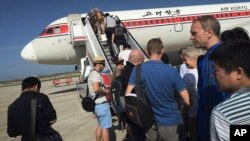 FILE - passengers board an Air Koryo plane bound for Beijing, at the Pyongyang International Airport in Pyongyang, North Korea. 