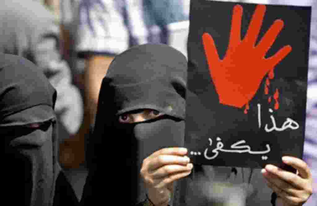 A Yemeni anti-government protester holds up a placard that reads 'This is enough' during an anti-regime demonstration calling on President Ali Abdullah Saleh to leave in the capital Sana'a, February 24, 2011