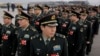 China Cuts Defense Spending as Economy Stumbles