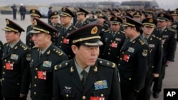 Delegates from China's People's Liberation Army (PLA) stand in line as they arrive at the Great Hall of the People to attend a session of National People's Congress in Beijing, March 4, 2016. China said Friday it will boost military spending by about 7 to 8 percent this year, the smallest increase in six years, reflecting slowing economic growth and a drawdown of 300,000 troops as Beijing seeks to build a more streamlined, modern military. 
