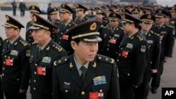 Delegates from China's People's Liberation Army (PLA) stand in line as they arrive at the Great Hall of the People to attend a session of National People's Congress in Beijing, March 4, 2016.