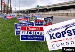 Political campaign signs are seen outside a polling station in Austin, Texas, March 5, 2018, ahead of the first statewide U.S. primary in the country's 2018 midterm election cycle.