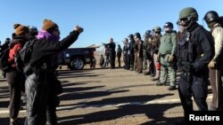 Police block the highway from protesters next to the pipeline route during a protest against the Dakota Access pipeline near the Standing Rock Sioux Reservation in St. Anthony, N.D., Nov. 11, 2016.