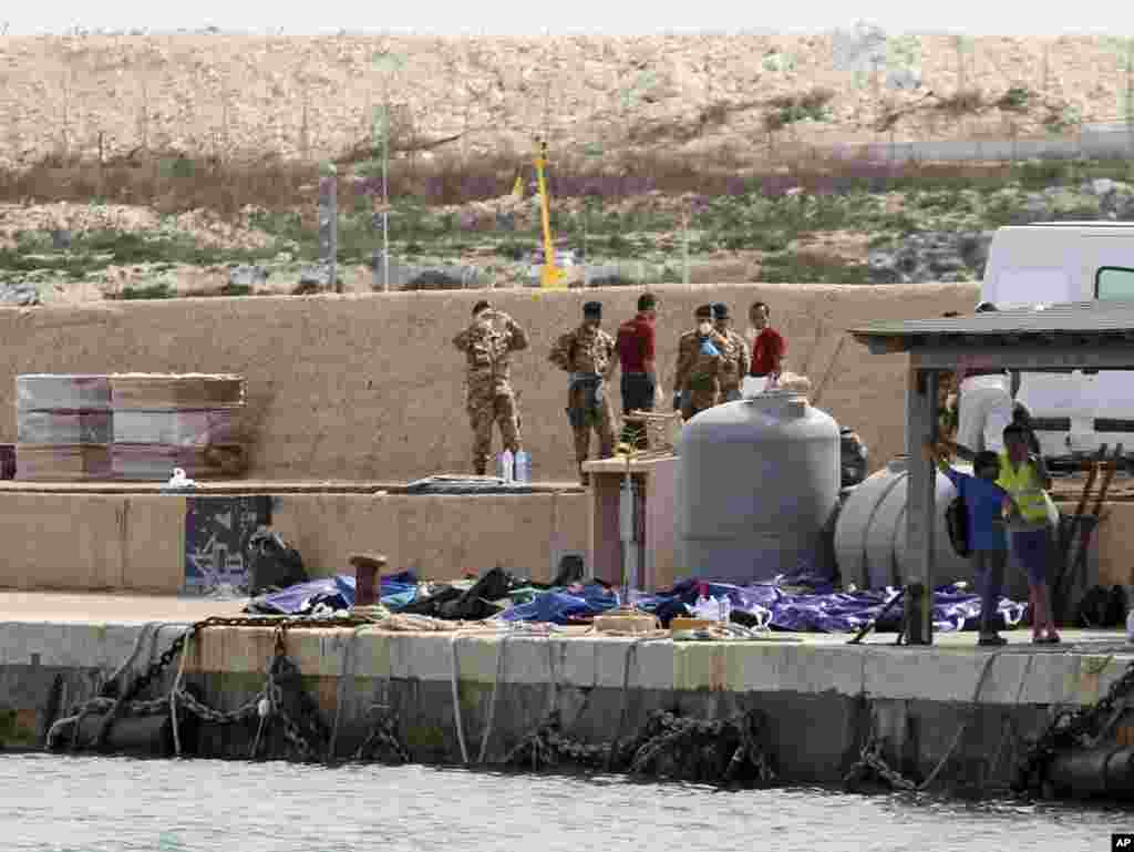 Bodies of drowned migrants are lined up in the port of Lampedusa, Oct. 3, 2013.