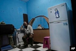 Egyptian Christian Ezzat Yaacoub Ishak, who fled el-Arish in northern Sinai two days ago due to fighting, sits in his newly rented apartment, in Ismailia, Egypt, Feb. 26, 2017.