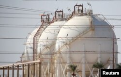 FILE - A plant's gas tanks are seen at the desert road of Suez city north of Cairo, Egypt, Aug. 14, 2016.