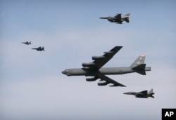 FILE - A U.S. Air Force B-52 bomber flies over Osan Air Base in Pyeongtaek, South Korea, Jan. 10, 2016. The bomber flew low over South Korea on Sunday, a show of force from the U.S. as a Cold War-style standoff deepened between ally Seoul and North Korea.