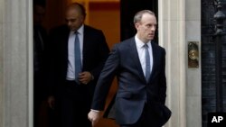 FILE - Britain's Secretary of State for Exiting the European Union Dominic Raab, right, leaves 10 Downing Street in London, Oct. 24, 2018.