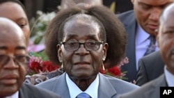 FILE: Zimbabwean president, Robert Mugabe, center, arrives in Pretoria, South Africa Tuesday, April 7, 2015.