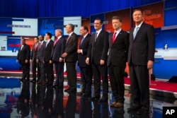 Republican presidential candidates from left, Chris Christie, Marco Rubio, Ben Carson, Scott Walker, Donald Trump, Jeb Bush, Mike Huckabee, Ted Cruz, Rand Paul, and John Kasich take the stage for the first Republican presidential debate at the Quicken Loa