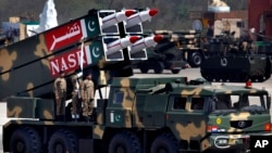 FILE - A missile is loaded on a vehicle during the Pakistan National Day parade in Islamabad, Pakistan, in March 2015. Pakistan's nuclear arsenal is on track to be the third largest in the world, one U.S. lawmaker said Wednesday.