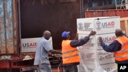 FILE - American aid goods are loaded onto a truck after it arrived by airplane, to be used in the fight against the Ebola virus spreading in the city of Monrovia, Liberia, Aug. 24, 2014.