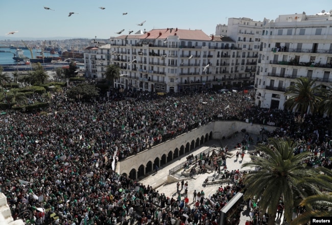 People gather during a protest over President Abdelaziz Bouteflika's decision to postpone elections and extend his fourth term in office, in Algiers, Algeria March 15, 2019.