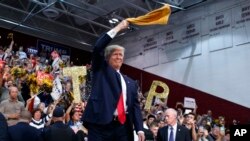 Republican presidential candidate Donald Trump waves a "Terrible Towel" as he arrives to speak at a campaign rally in Pennsylvania. 