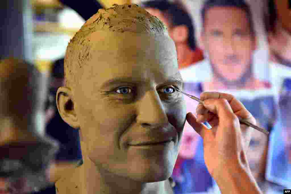 Italian sculptor Francesca Romana Di Nunzio works on a bust depicting retired footballer and AS Roma midfielder Francesco Totti at her studio in Rome. The bust will be used by the Museo delle Cere (Wax Museum) in Rome to create a wax figure of the iconic AS Roma captain.