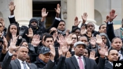 Congressional staff members gather on Capitol Hill in Washington, Thursday, Dec. 11, 2014, to raise awareness of the recent killings of black men by police officers, both of which did not result in grand jury indictments. 