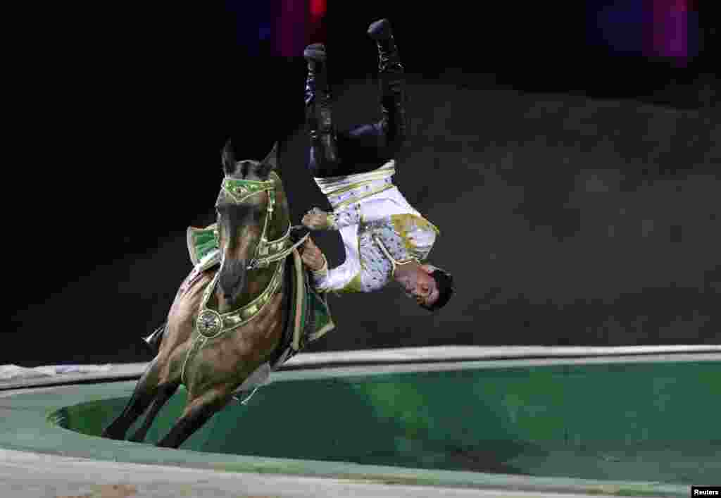 A Turkmenistan man performs on a horse during the opening ceremony of 2014 International Akhal-Take Horses Association Special Conference and China Horse Culture Festival at Forbidden City, in Beijing, China.