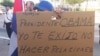 FILE - A protester holds up a sign asking President Obama not to renew relations with Cuba during a rally in solidarity with Cuban dissidents in downtown Miami, Florida.