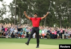 FILE - Tiger Woods celebrates on the 18th hole to win the 2019 Masters. (REUTERS/Lucy Nicholson/File Photo)