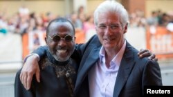 Richard Gere (R) hugs Ben Vereen as they arrive for the "Time Out of Mind" gala at the Toronto International Film Festival (TIFF) in Toronto, Canada, Sept. 7, 2014.