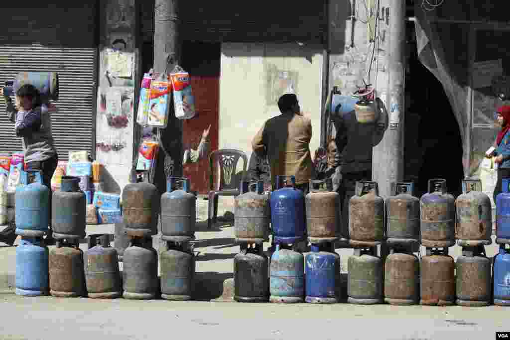 Gas cylinders are displayed for sale on a street in Aleppo, March 24, 2013.