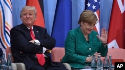 U.S. President Donald Trump, left, and German Chancellor Angela Merkel are seen at the panel discussion of the Women's Entrepreneur Finance event on the second day of the G-20 summit in Hamburg, Germany, July 8, 2017.