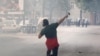 A demonstrator hurls a stone during a protest against the enthronement of Bishop Joanikije in Cetinje, Montenegro, September 5, 2021. REUTERS/Stevo Vasiljevic