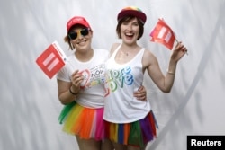 Katrina, 25, left, and Devon, 22, pose for a portrait during the Resist March against President Donald Trump in West Hollywood, California, June 11, 2017.