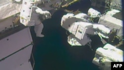 This NASA TV video grab image obtained on Oct. 10, 2017 shows astronauts outside the International Space Station to complete repairs to the station's robotic arm. Randy Bresnik is leading the outing, accompanied by Mark Vande Hei. (AFP PHOTO/NASA TV/HANDOUT)