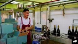FILE - In this Sunday, May 20, 2007 file photo, a worker packs bottles of Egyptian-produced wine at the plant of EgyBev, near the Red Sea resort city of El Gouna, Egypt. 