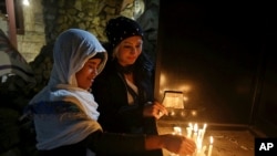 Iraqi Christians light candles after a Christmas Eve Mass in St. Joseph's Church in Baghdad, Iraq. (File)