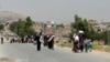 FILE - Syrians carry supplies as they return to the rebel-held Damascus suburb of Moadamiyeh near Damascus, July 14, 2014. A protest in 2011 sparked a civil war that has killed more than 300,000 people and displaced more than 13 million people at home and abroad.