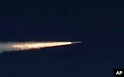 In this photo made from the footage taken from Russian Defense Ministry official web site on Sunday, March 11, 2018, a Russia's Kinzhal hypersonic missile flies during a test in southern Russia.