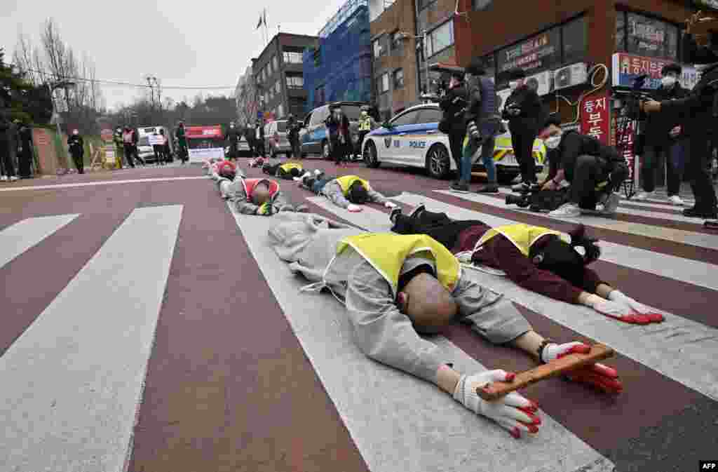South Korean Buddhist monks and Myanmar nationals living in South Korea march and bow during a protest against Myanmar&#39;s military coup in front of the Myanmar embassy in Seoul.