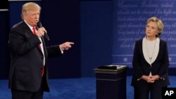 Republican presidential nominee Donald Trump speaks to Democratic presidential nominee Hillary Clinton during the second presidential debate at Washington University in St. Louis, Oct. 9, 2016.