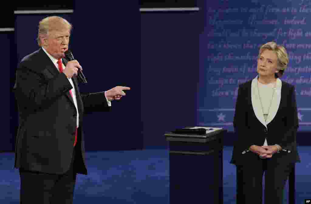 Republican presidential nominee Donald Trump speaks to Democratic presidential nominee Hillary Clinton during the second presidential debate at Washington University in St. Louis, Sunday, Oct. 9, 2016. (AP Photo/John Locher)