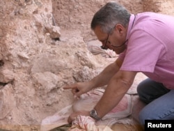 Dr. Jean-Jacques Hublin points out the new finds at Jebel Irhoud in Morocco in this undated handout photo obtained by Reuters, June 7, 2017.