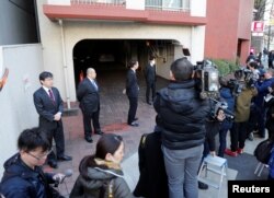 Journalists are seen in front of the residence of former Nissan Motor Chairman Carlos Ghosn in Tokyo, Japan, April 4, 2019.