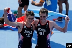 Britain's Alistair, right, and Jonathan Brownlee react after the men's triathlon event of the 2016 Summer Olympics in Rio de Janeiro, Brazil, Aug. 18, 2016. Alistair won the gold medal and Jonathan the silver in the event.